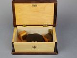 a small wooden box with a clock inside of it