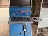a laptop computer sitting on top of a blue stand