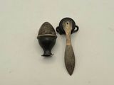 two small metal objects on a white surface