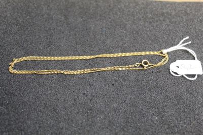 a close up of a gold chain with a tag on it