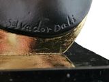 a black and gold cake that is on top of a table