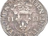 a close up of a coin with a coat of arms on it