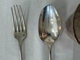 two spoons and a fork sitting on a table