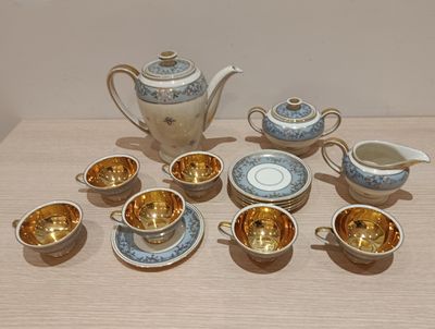 many cups and saucers sitting on a table