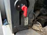 a close up of a machine with a red handle
