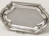 a silver plate with a decorative design on it