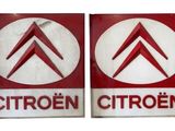 two red and white signs with the words citroen and citroen on them