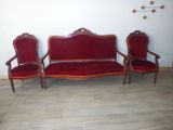three red chairs and a couch in a room
