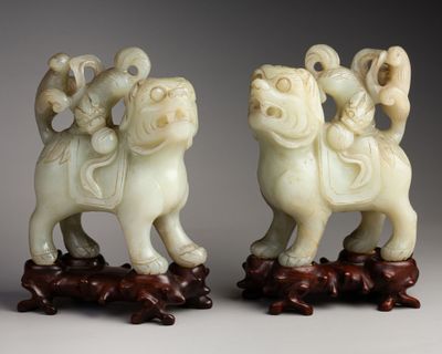 pair of chinese carved ivory figurines of two men on horses