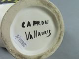 a close up of a vase with writing on it