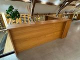 a wooden bar with wine glasses on top of it