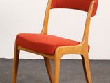 an image of a wooden chair with red upholstered seat