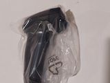 a black object in a plastic bag on a white surface