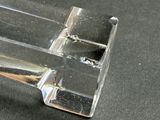 a clear piece of glass that is on a table