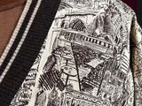 a close up of a sweater with a picture of a city