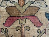 a close up of a rug with a cross on it
