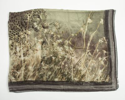 a scarf with a picture of a leopard in the grass