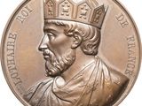 une image représentant une médaille d'argent sur laquelle figure un homme coiffé d'une couronne