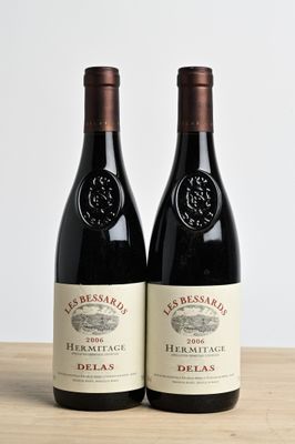 two bottles of wine sitting on top of a wooden table