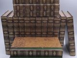 several books stacked on top of each other on a white surface