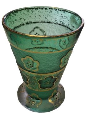 a green glass vase with a design on it