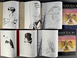a lot of books that are open on a table