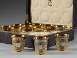 six cups in a case that are sitting on a table