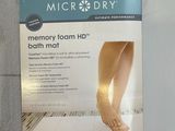 a picture of a memory foam bed mat with a picture of a woman ' s feet