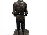 statue of a boy standing on a base with his hands in his pockets