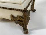 a white marble clock with a gold decoration on it