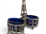 two blue glass bowls with a tower in the background