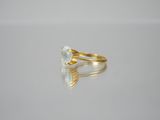 a close up of a gold ring with a white diamond