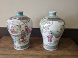 two vases that are sitting on a wooden table