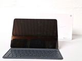 a laptop with a keyboard on a table next to a box
