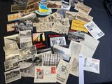 a lot of old postcards on a black table