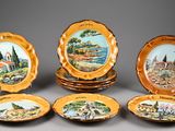 several plates with a picture of a village and a church on them