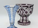 two vases sitting next to each other on a white surface