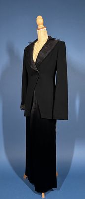 a mannequin wearing a black suit on a mannequin stand