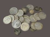 a pile of silver coins sitting on a table