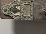 a metal object that is on top of a piece of wood