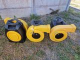 two yellow and black blowers sitting next to each other on the ground