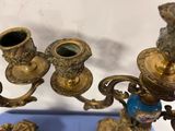 brass candelab with blue vases on a blue tray