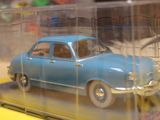 a blue toy car in a clear case on a table