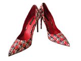 a pair of red and black high heeled shoes on a white background