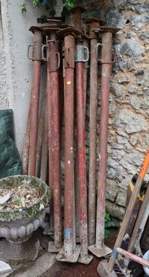 a pile of old tools and tools outside of a building