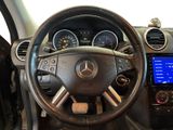 a steering wheel and dashboard of a car with a clock on it