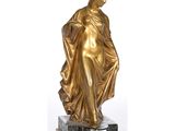 statue of a woman in a draped dress on a marble base