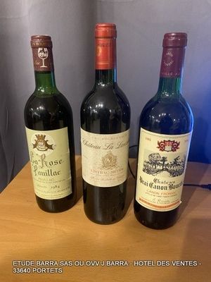 three bottles of wine are lined up on a wooden table