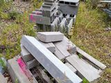 a pile of concrete blocks sitting in the grass