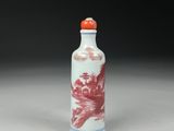 an orange and white porcelain snuff bottle with a dragon on it